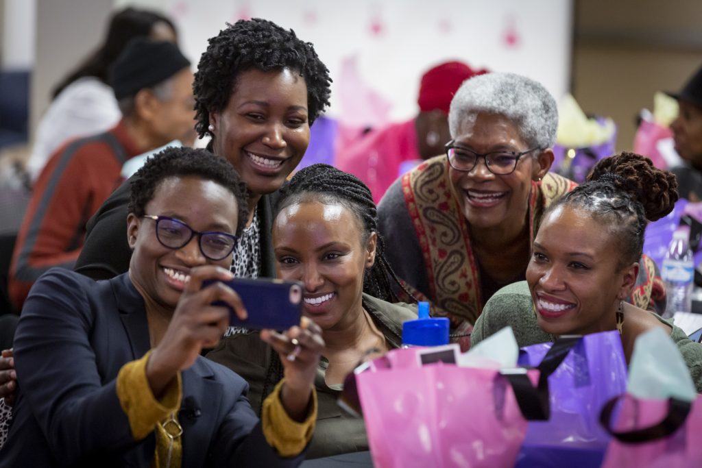 Attendees gather for a group photo during the World Cancer Day Celebration, February 8, 2020, hosted by The Cierra Sisters at the Langston Hughes Performing Arts Center in Seattle, Washington.