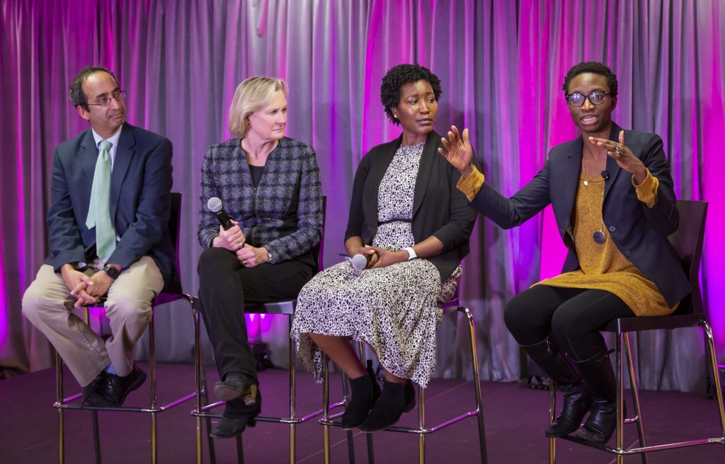 Dr. Kemi Doll, right, speaks during the World Cancer Day Celebration, February 8, 2020, hosted by The Cierra Sisters at the Langston Hughes Performing Arts Center in Seattle, Washington. Other panelists include Dr. Menoj Menon, Dr. Julie Gralow, Dr. Rachel Issaka.